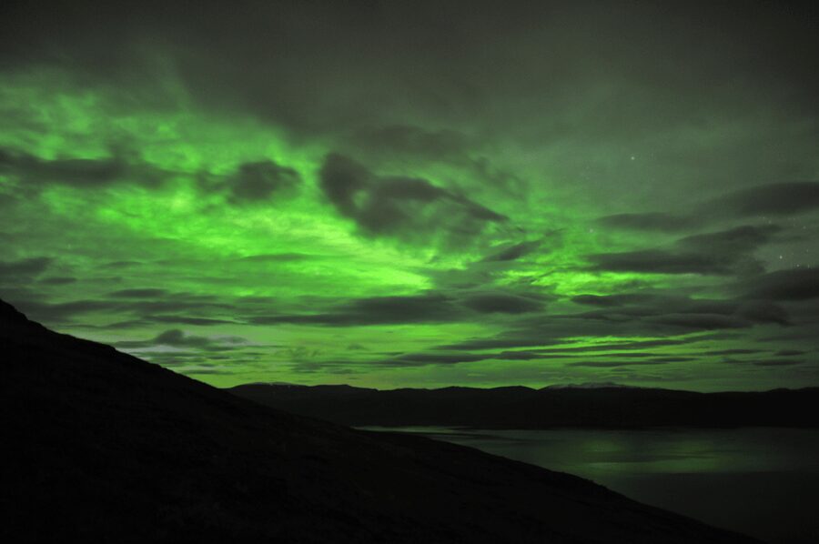 Abisko: Guided Autumn Aurora Chase with Hotel Transfers - Lake Torneträsk and reflections on the water