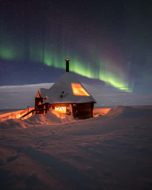 Kilpisjärvi: Northern Lights Snowmobile Tour with Photos - A campfire stop with a hot drink and pastry