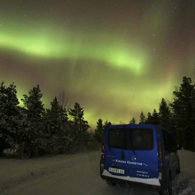 Kiruna: Northern Lights Minivan Chase with Warm Drink - Waiting outside with Lapland snacks