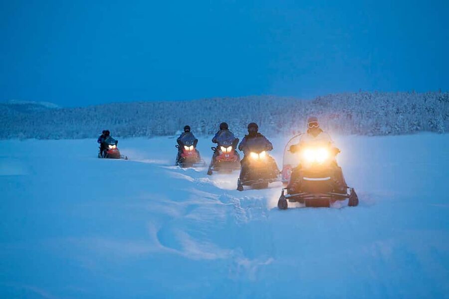 Kiruna: Northern Lights Snowmobile Tour with Dinner - Searching the sky for northern lights