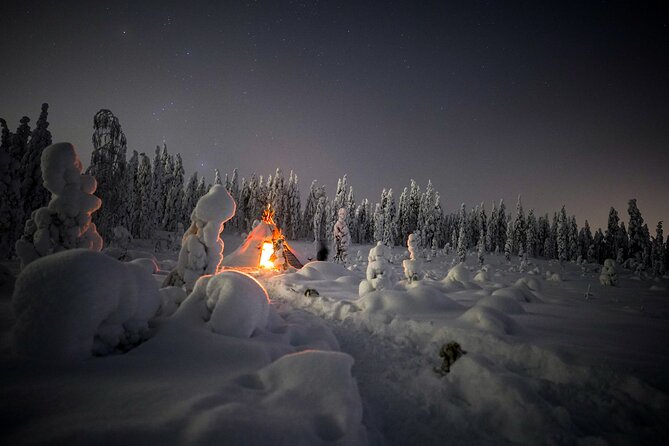 Night Snowshoeing Adventure under the Northern Lights - A campfire made the old-fashioned way