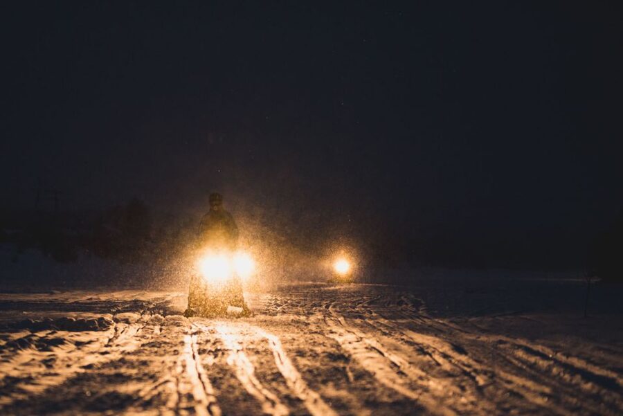 Rovaniemi: Search for Northern Lights Snowmobiling Trip - Riding into Rovaniemi’s snowy night